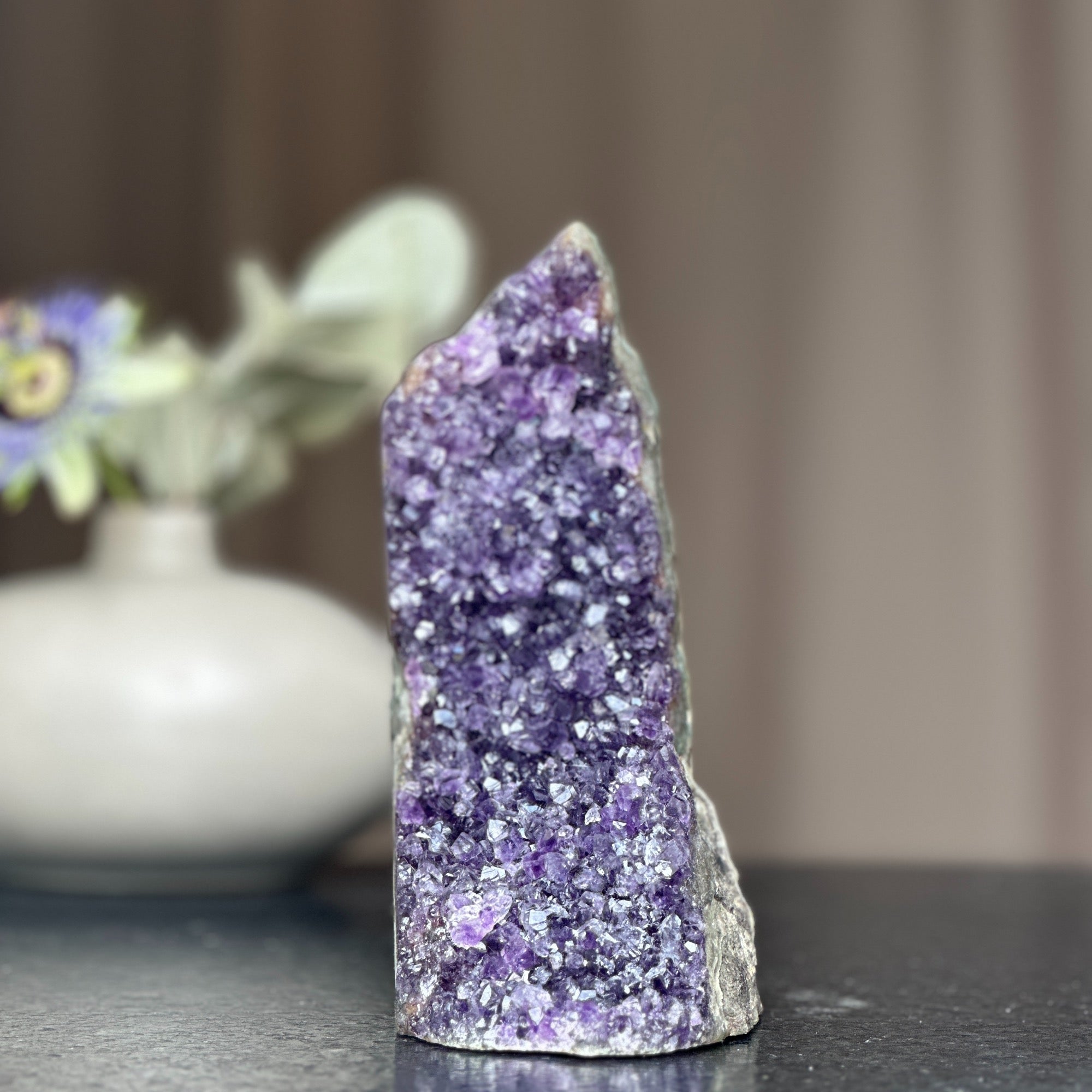 Huge deep purple amethyst crystal geode with a cut base, 6.5 inches tall.