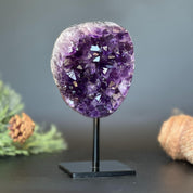 Deep purple Uruguayan amethyst geode on a black metal stand, 7 inches tall.