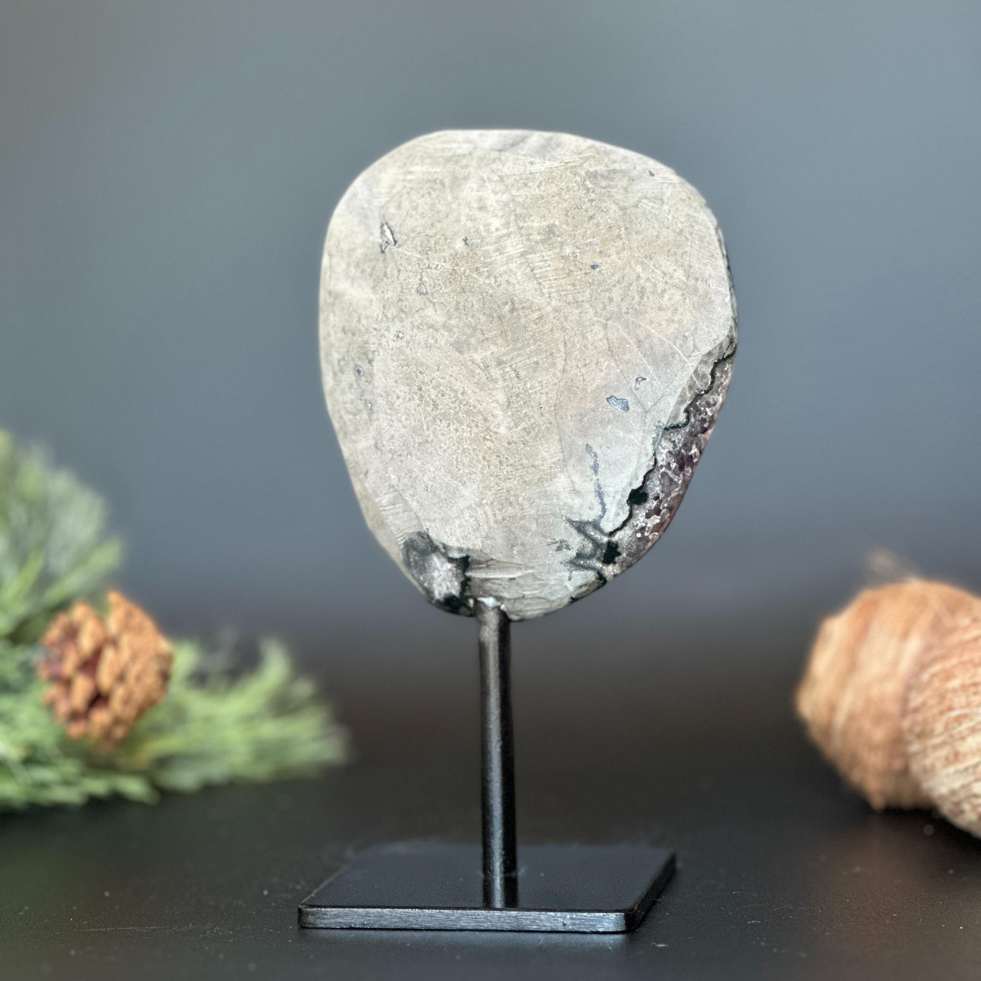 Large, deep purple Uruguayan amethyst geode on a black metal stand, 7 inches tall.