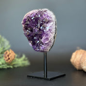 Deep purple Uruguayan amethyst geode on a black metal stand, 7 inches tall.