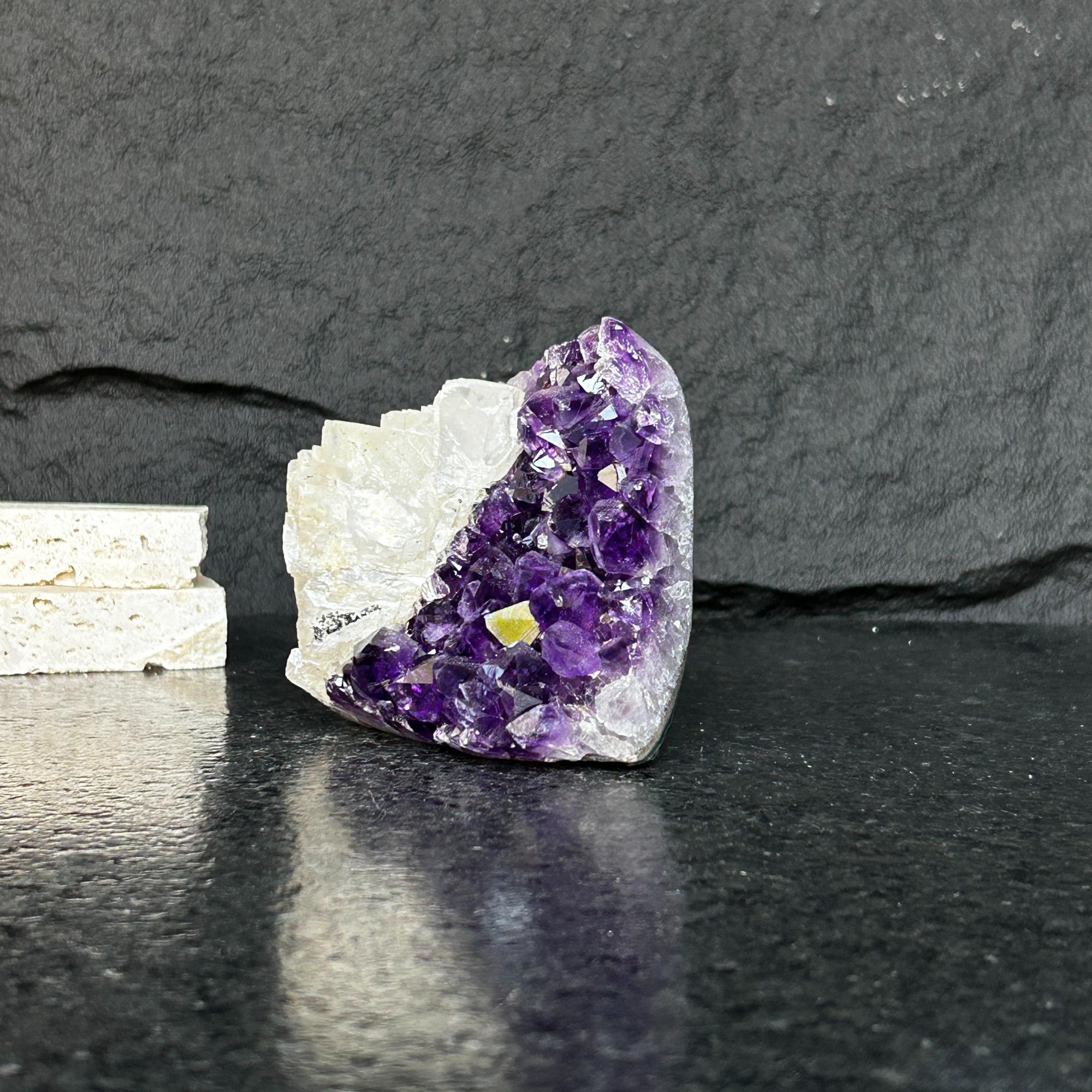 Large, dark purple Uruguayan amethyst geode cluster with white crystal base.