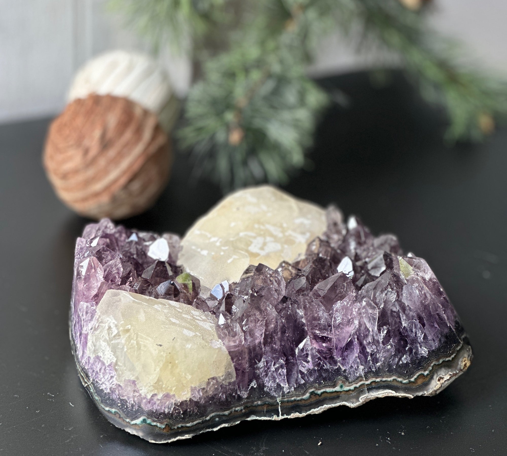Large, deep-purple amethyst cluster with prominent crystal points and unique light-yellow calcite formations.