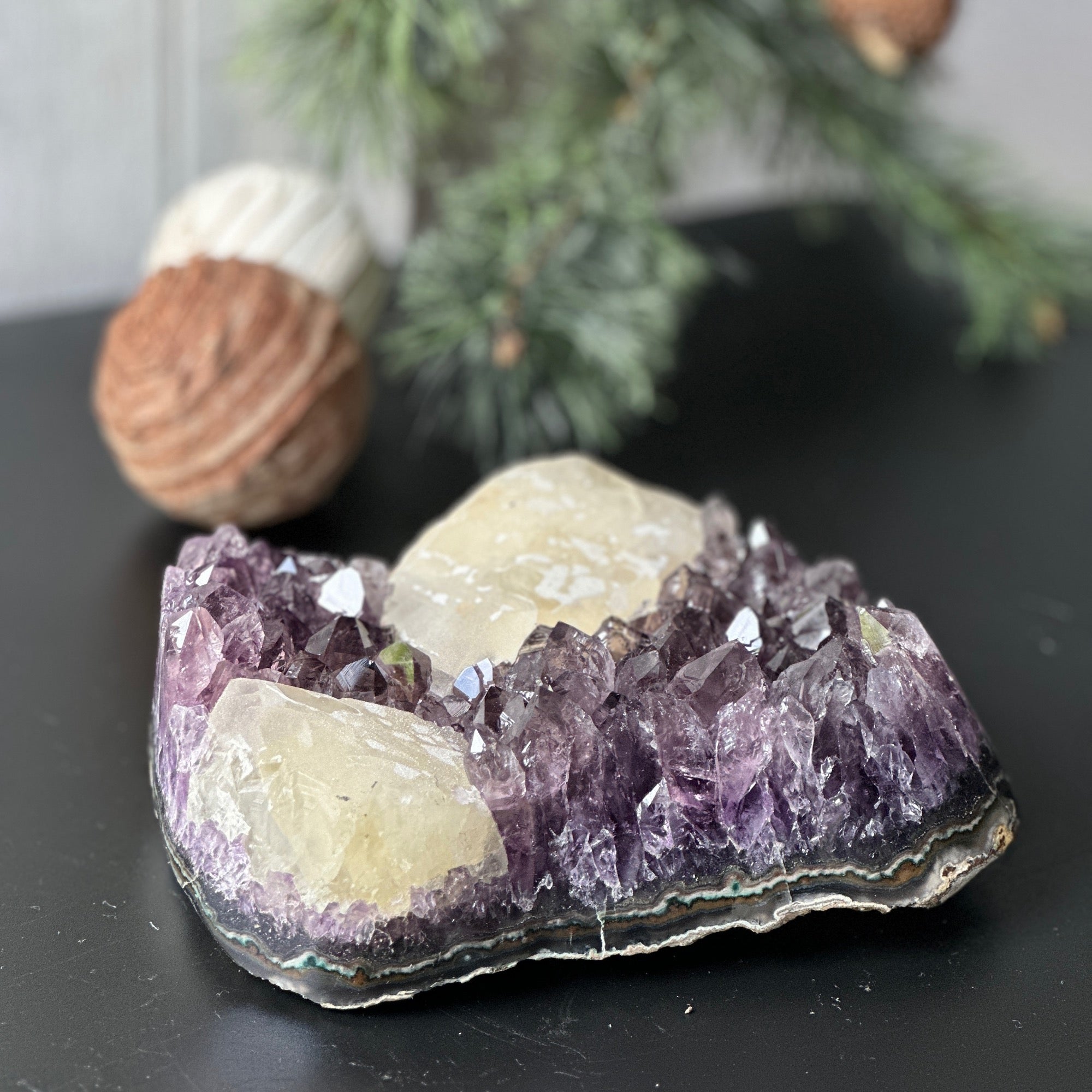 Large, deep-purple amethyst cluster with prominent crystal points and unique light-yellow calcite formations.