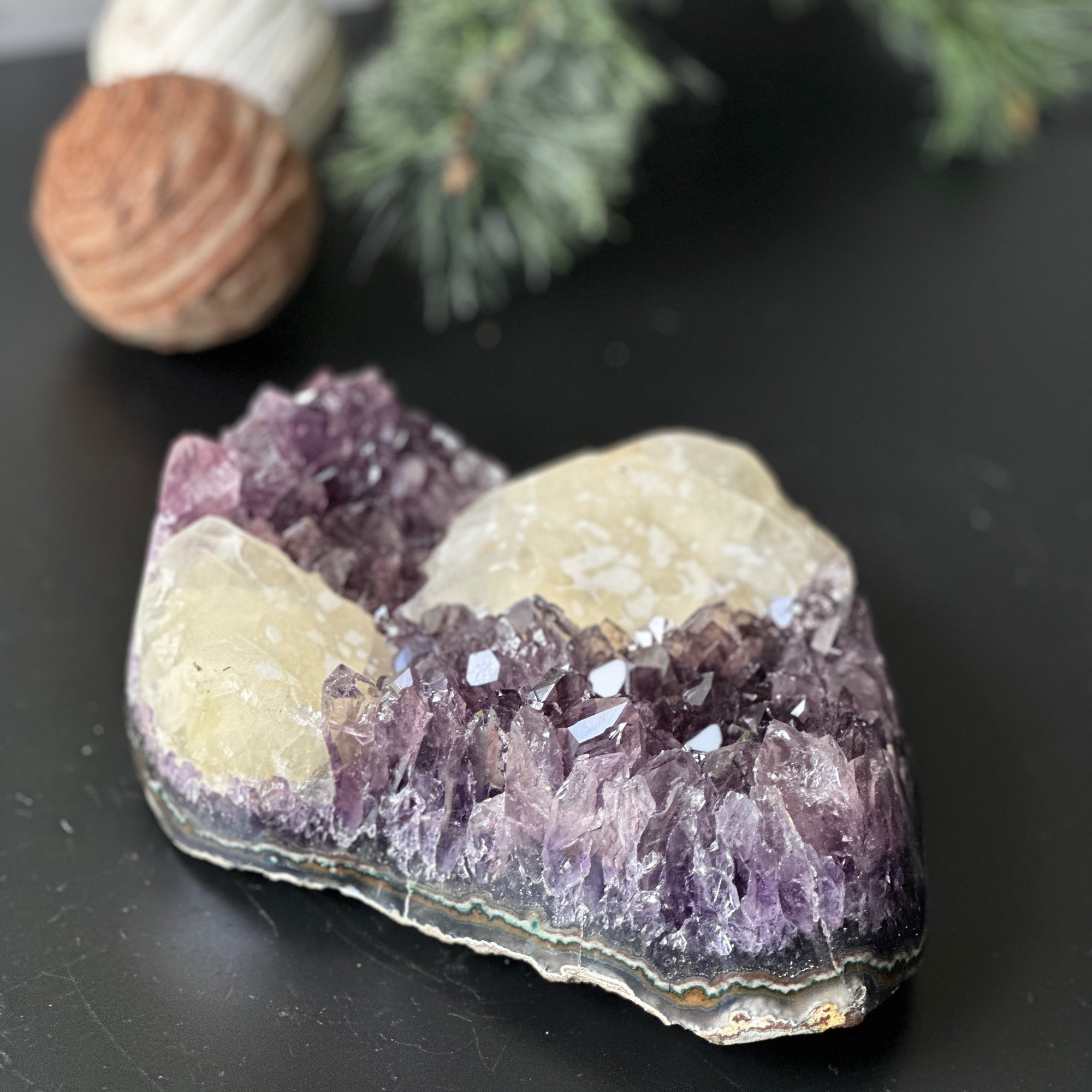 Large, deep-purple amethyst cluster with impressive crystal points and unique light yellow calcite formations.