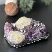 Large, deep-purple amethyst cluster with prominent crystal points and unique light-yellow calcite formations.