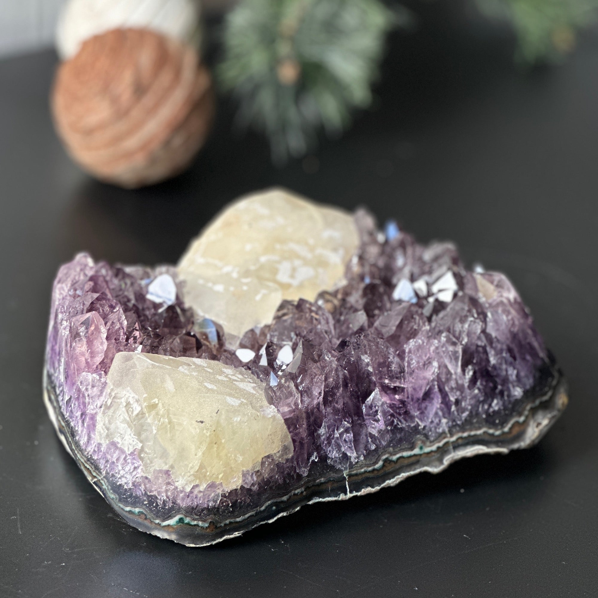 Large, deep-purple amethyst cluster with prominent crystal points and unique light-yellow calcite formations.