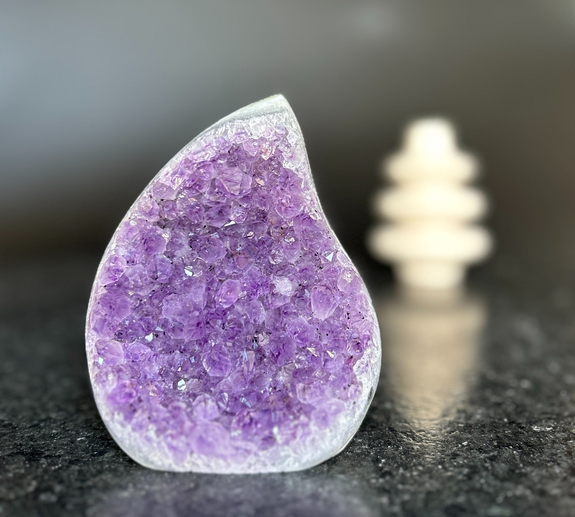 Large, teardrop-shaped natural amethyst crystal with deep purple druzy and polished edges.