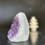 Large natural amethyst crystal geode, 5-inch tall, with vibrant purple clusters and polished gray edges.