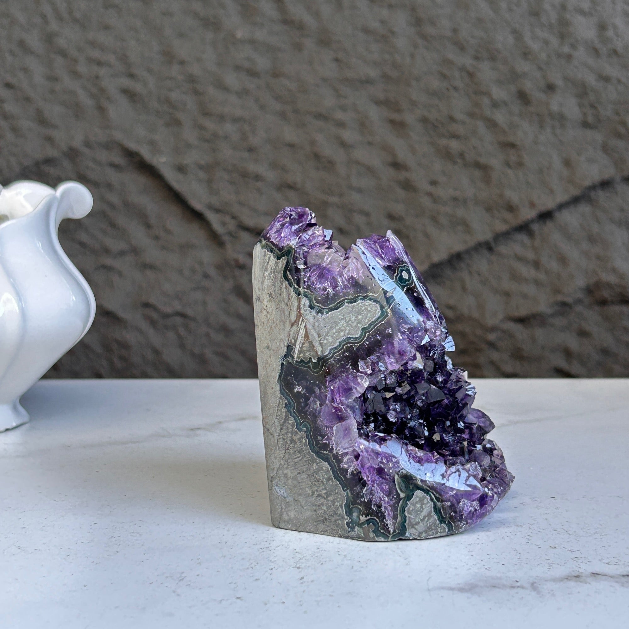 Vibrant deep purple amethyst geode crystal cluster, 4 inches tall, with natural grey rock and unique formations.