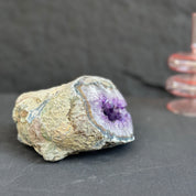 Large Uruguayan amethyst geode with deep purple crystals and agate formations.