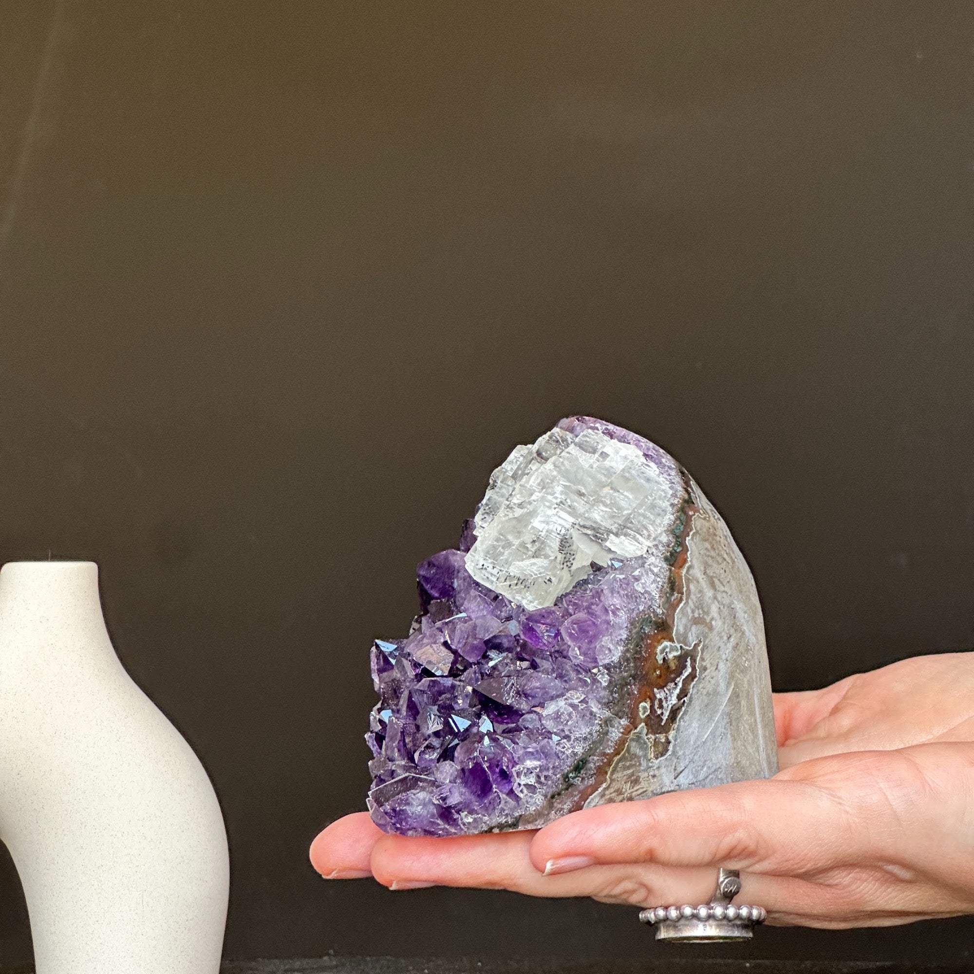 Hand holding a deep purple Uruguay amethyst crystal geode, 3x3 inches, 1.2 lb.