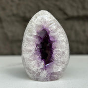 Polished amethyst geode egg, 5-inch tall, with sparkling purple crystals inside.