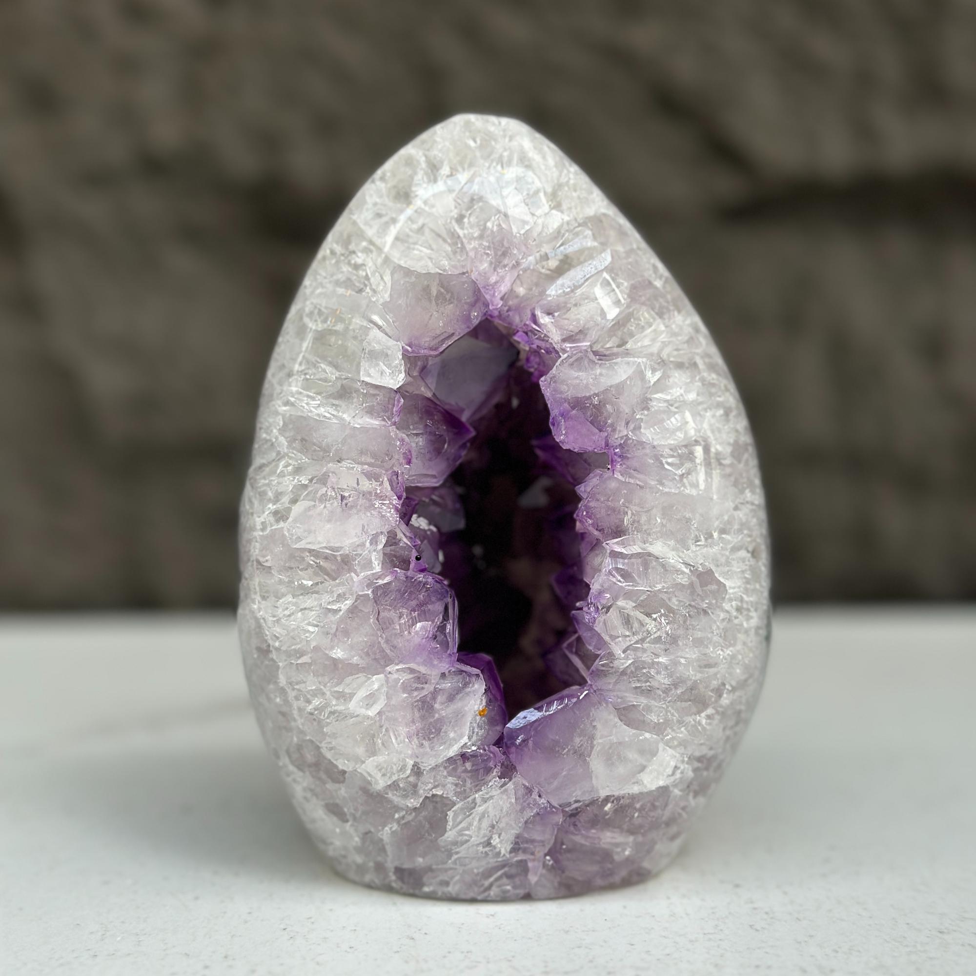 Polished amethyst geode egg, 5-inch tall, with sparkling purple crystals inside.