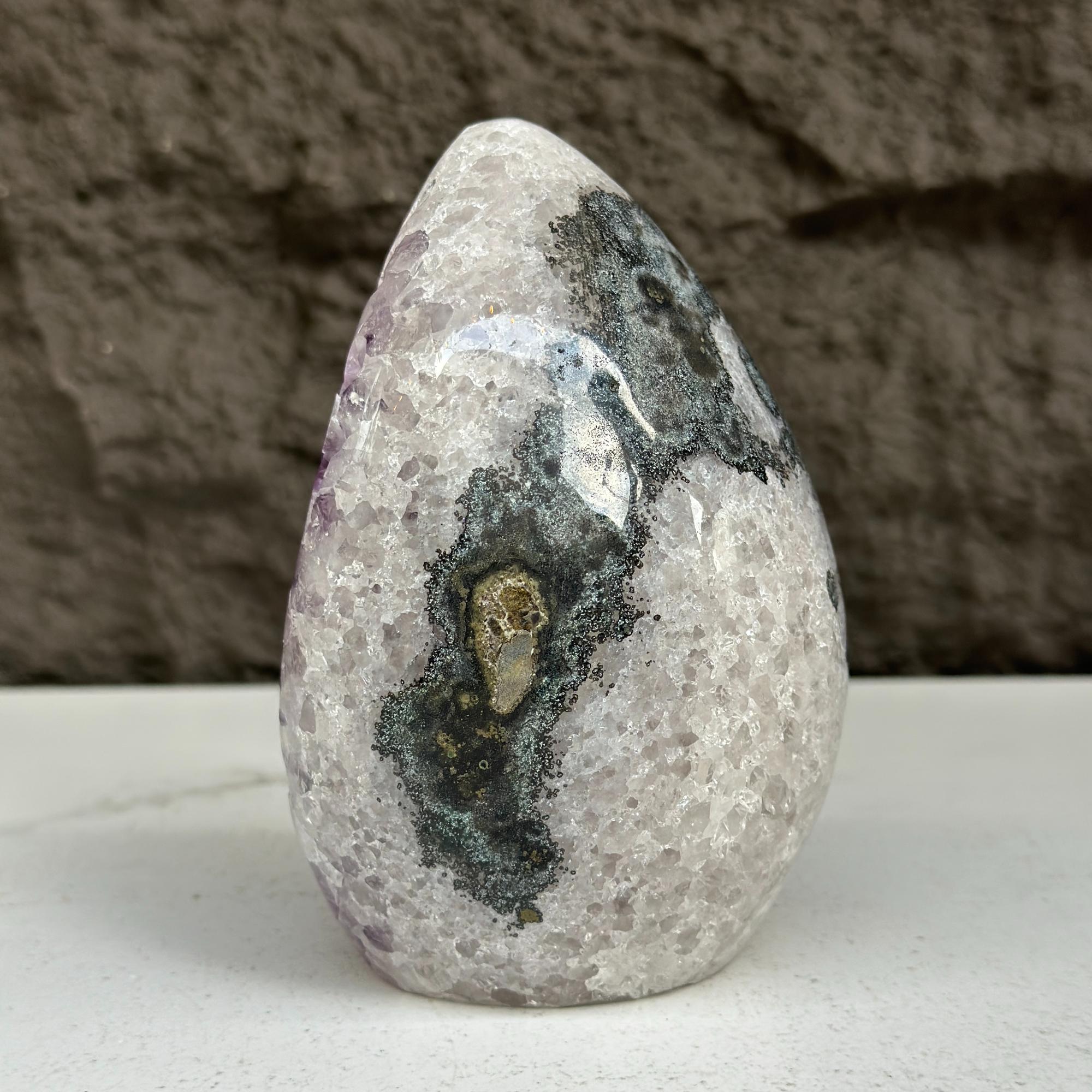 Polished quartz, amethyst, and agate stone egg, 5-inch tall, with dark and light natural patterns.
