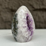 Polished quartz, amethyst, and agate stone egg, 5-inch tall, with sparkling purple crystals inside.