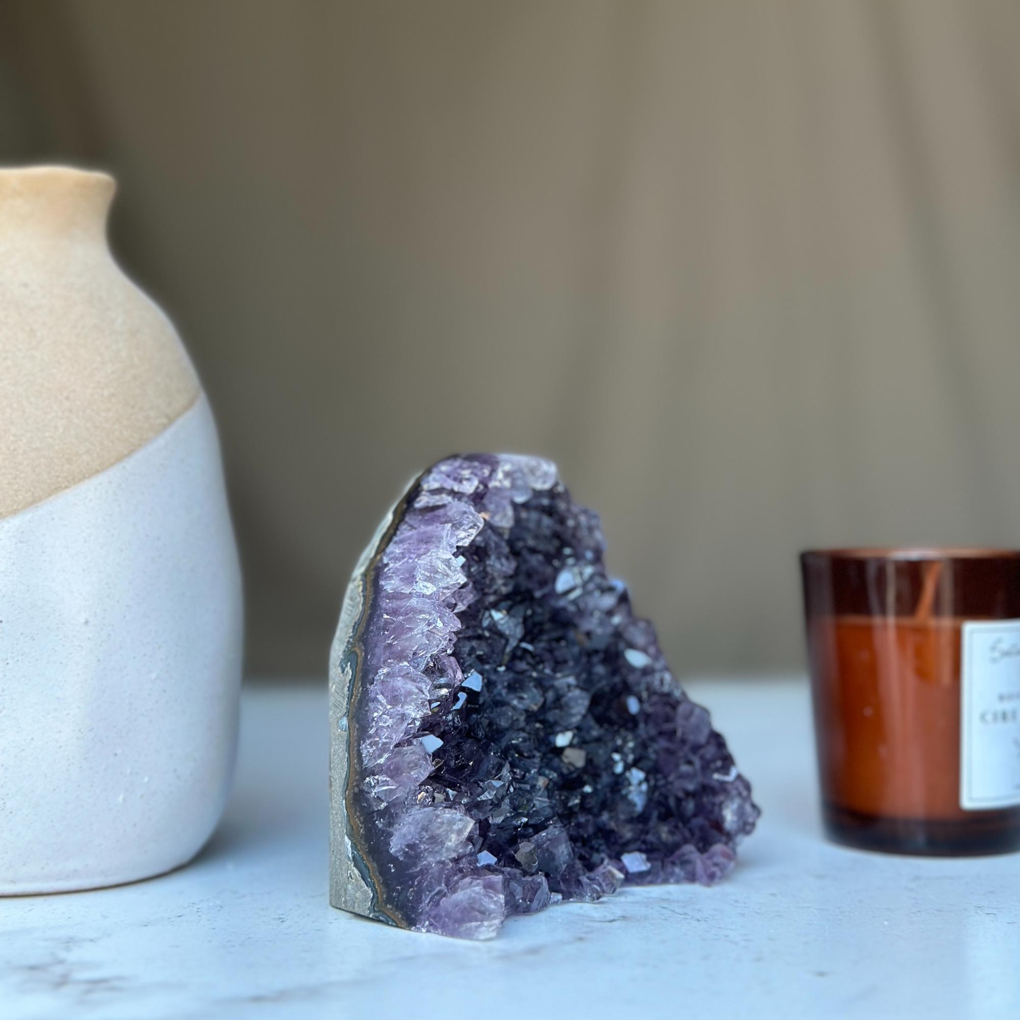 Vibrant deep purple Uruguayan amethyst geode cluster, a natural cathedral crystal with sparkling points.