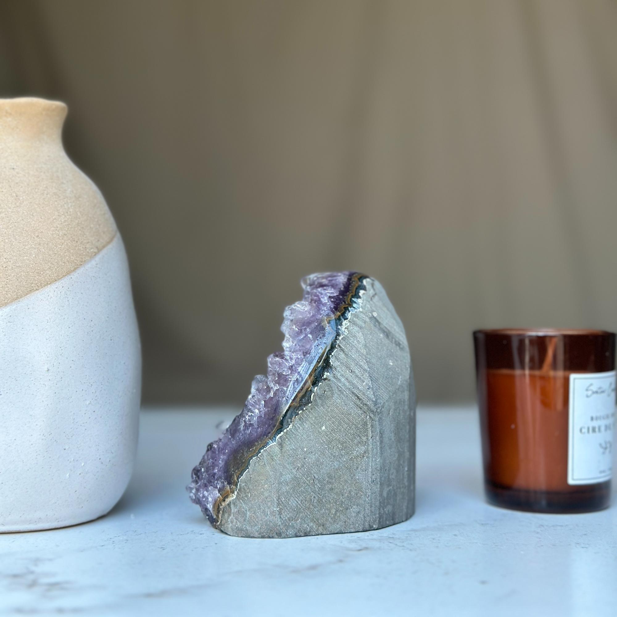 Vibrant deep purple Uruguayan amethyst geode cluster, 3.5-inch tall, with natural gray rock base.