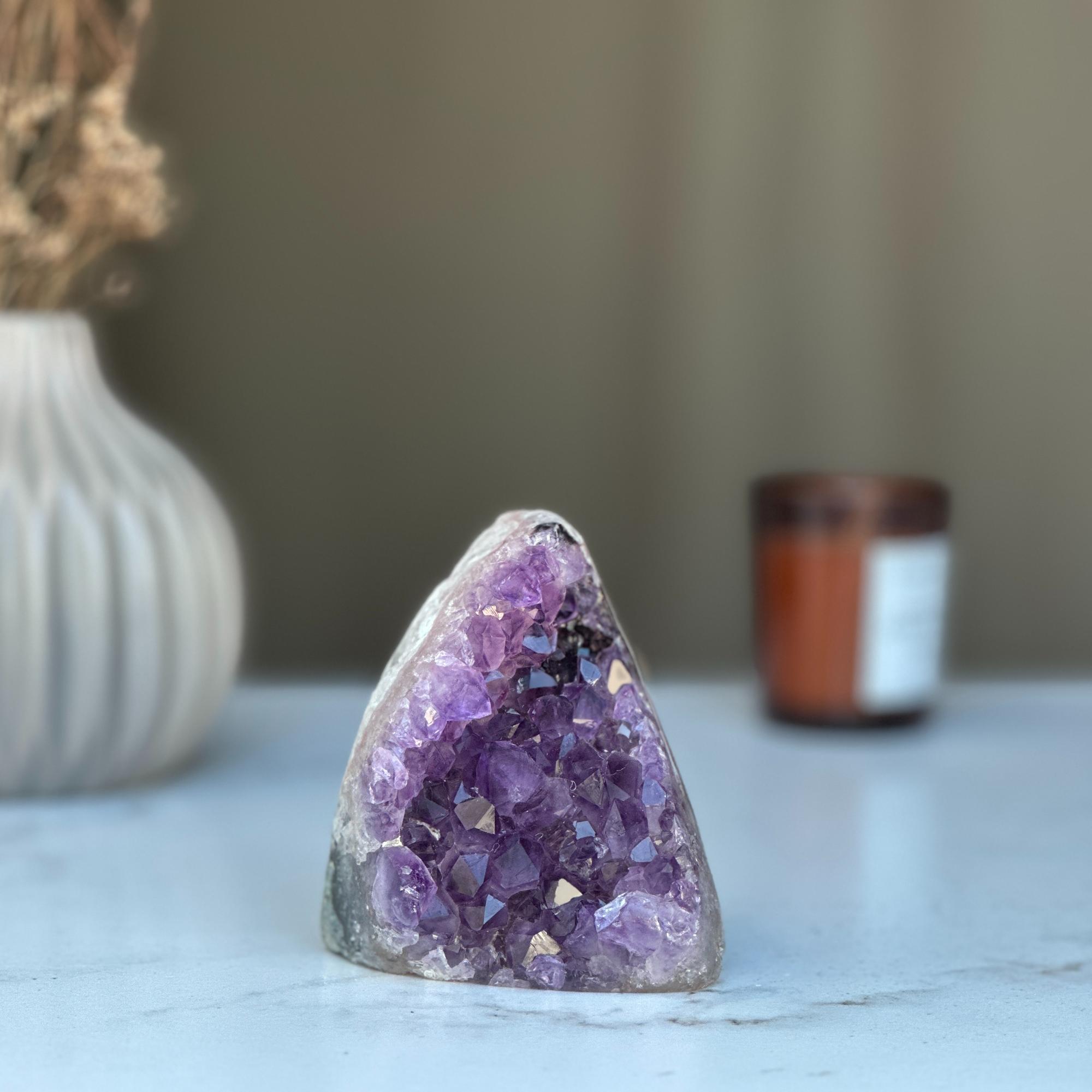 Raw purple amethyst geode cluster, 3.5-inch tall, on a white marble surface.