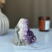 Raw purple amethyst geode crystal cluster, 3.5-inch tall, with white and gray rock casing.