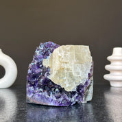 Vibrant deep purple amethyst geode cluster with a prominent creamy white crystal formation, 5.5 inches tall.
