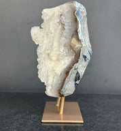 white geode crystal on a bronze stand 