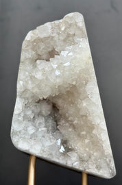 Crystal geode on a stand against a dark background