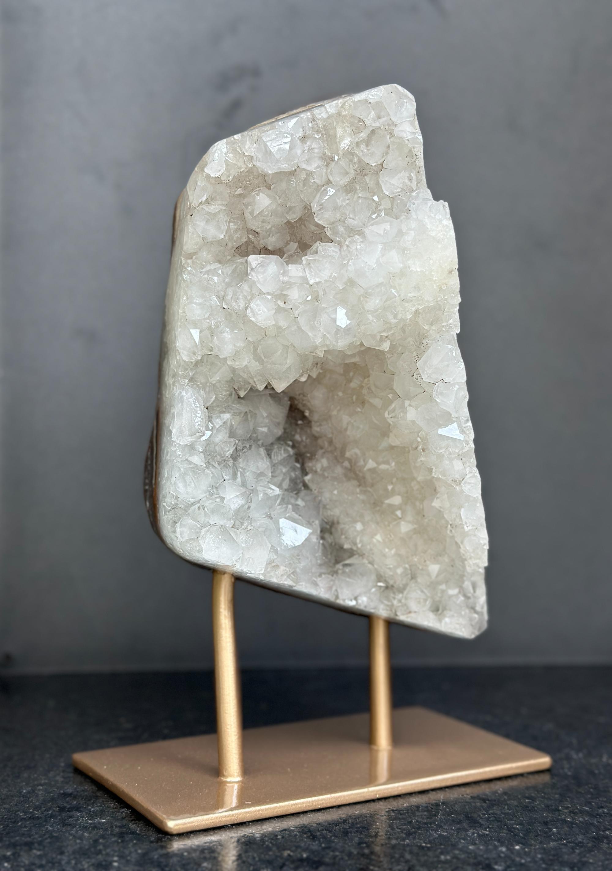 Crystal rock on a gold stand against a dark background