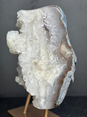 Geode crystal on a stand against a dark background
