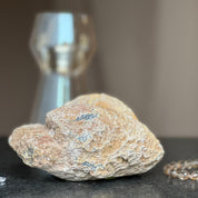 Large natural quartz crystal geode cave with a textured brown and tan exterior.