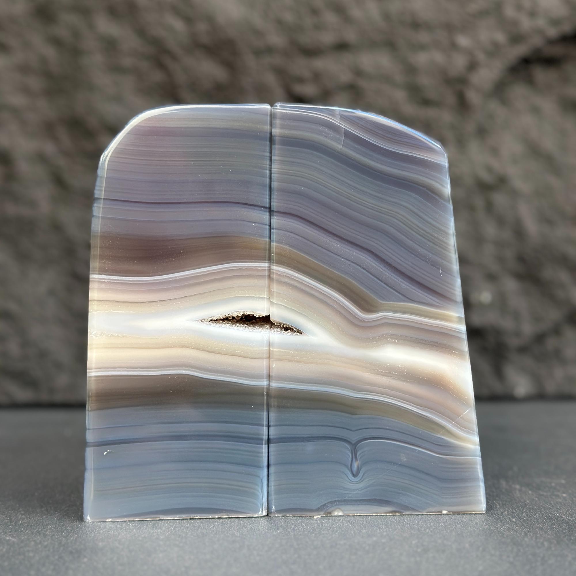 Striped agate stone on a gray surface with a blurred background