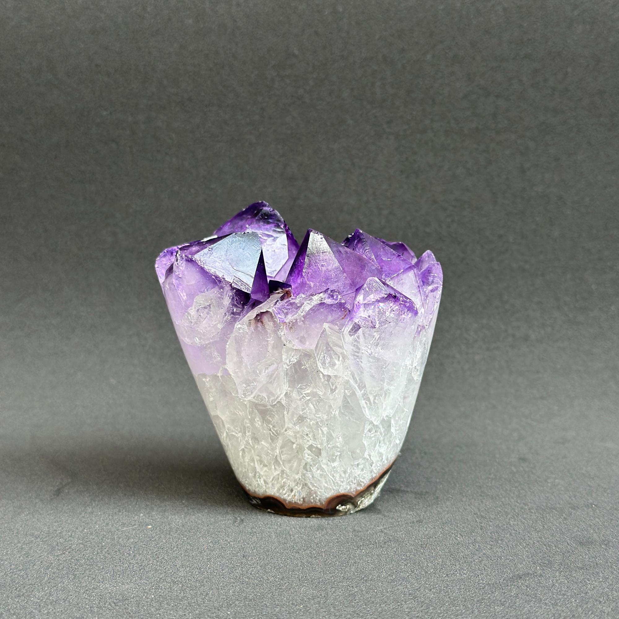 Amethyst crystal on a gray background