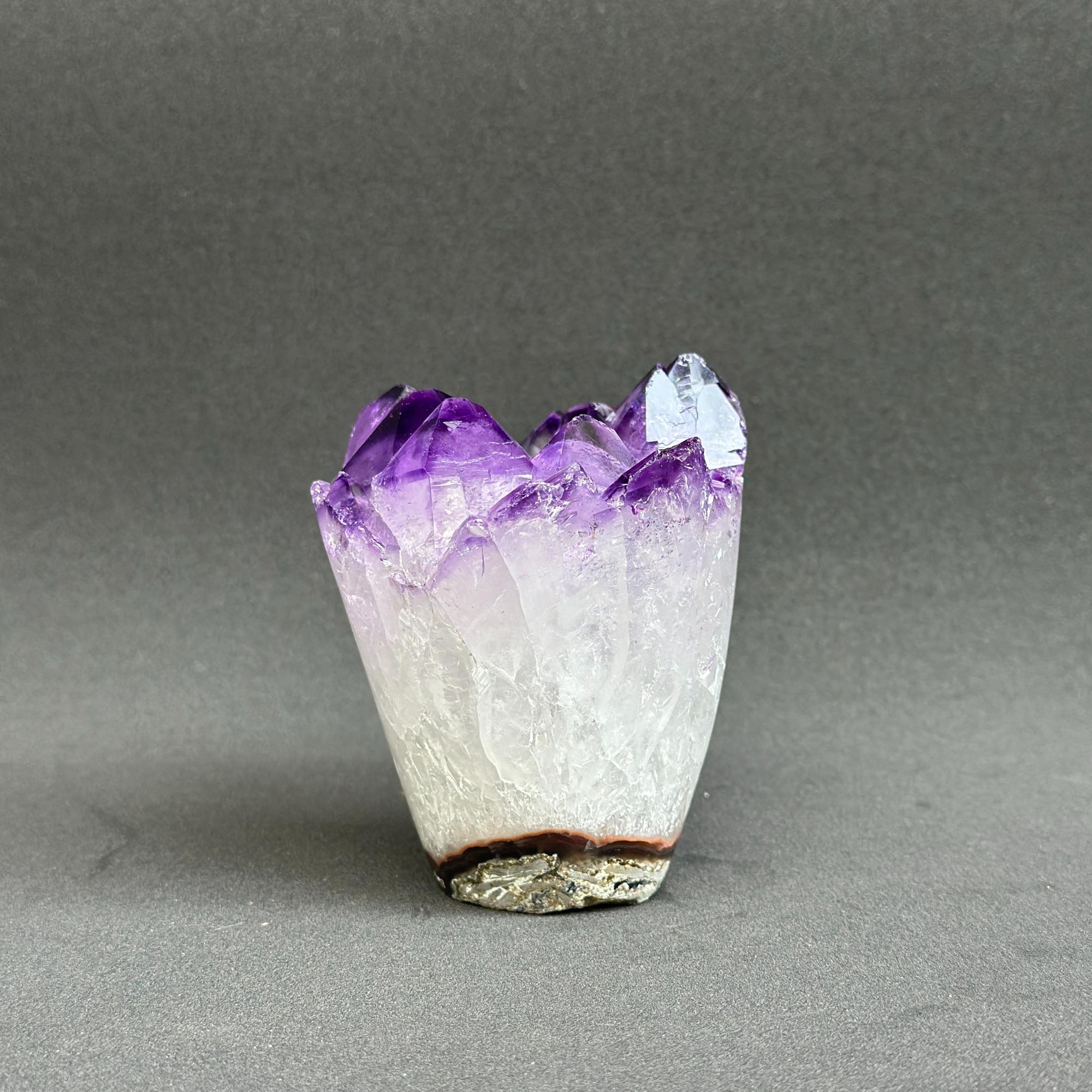 Amethyst crystal on a gray background