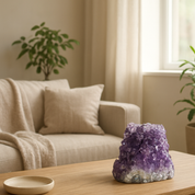 Vibrant purple amethyst geode cave with agate formations on a wooden table in a minimalist living room.