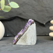 Geode with purple interior on a dark surface