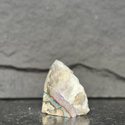 Geode crystal on a dark slate background