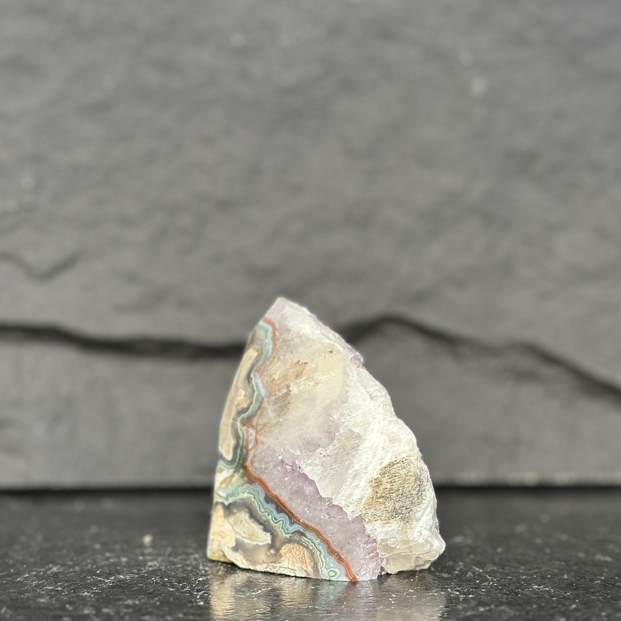 Geode crystal on a dark slate background