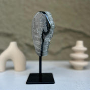 Crystal rock on a black stand with a blurred background