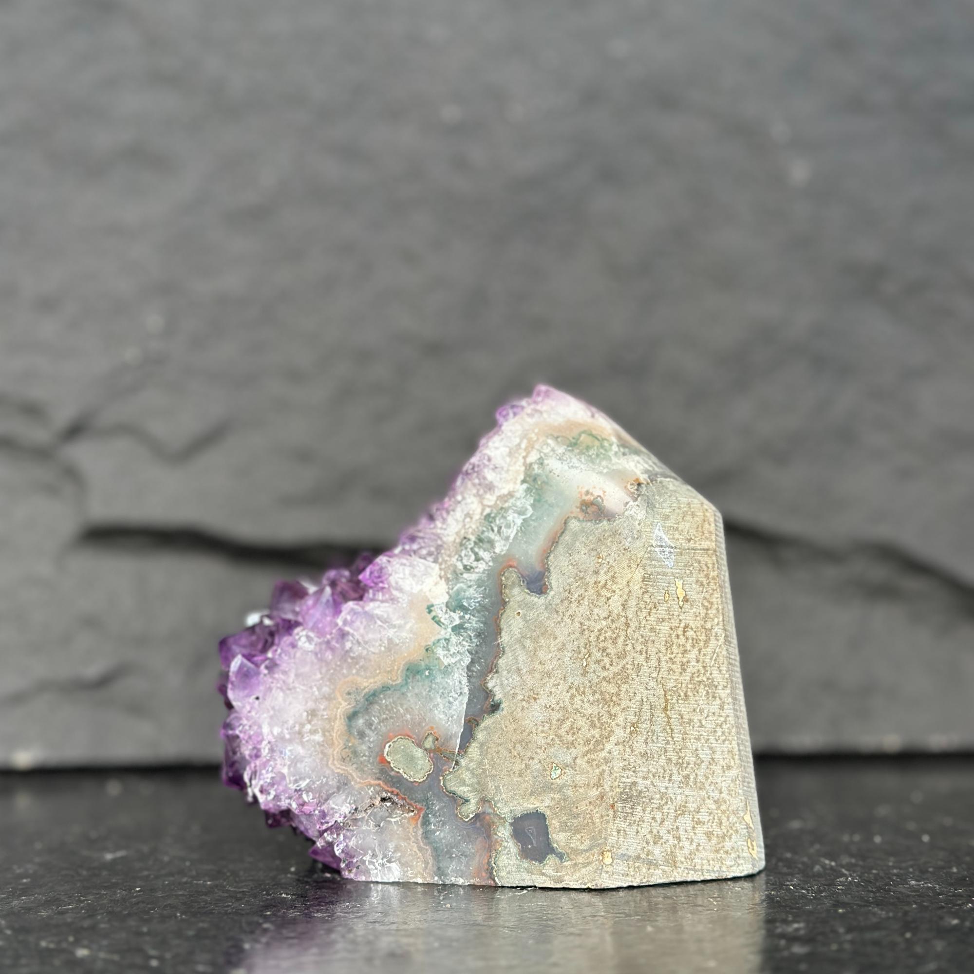 Mineral specimen with purple and white colors on a dark background