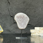 Decorative stone on a stand against a dark stone background