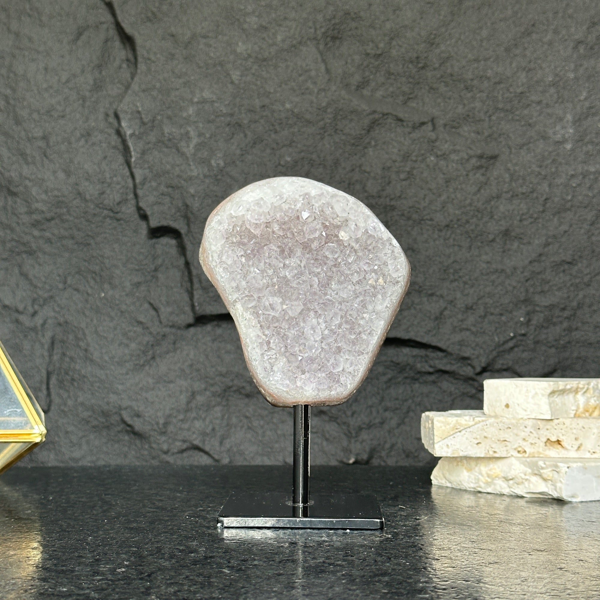 Decorative stone on a stand against a dark stone background