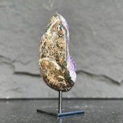 Decorative crystal on a stand against a gray background