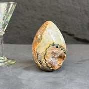 Decorative stone with a glass object on a gray surface