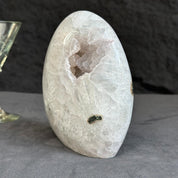 Crystal geode on a gray surface with a dark background