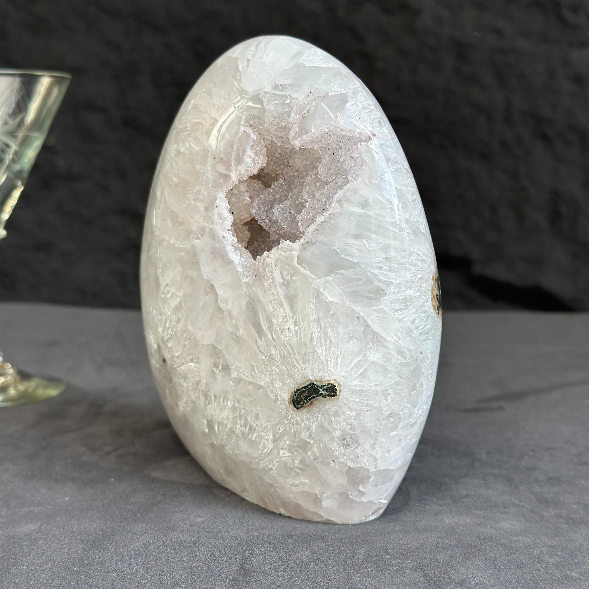 Crystal geode on a gray surface with a dark background