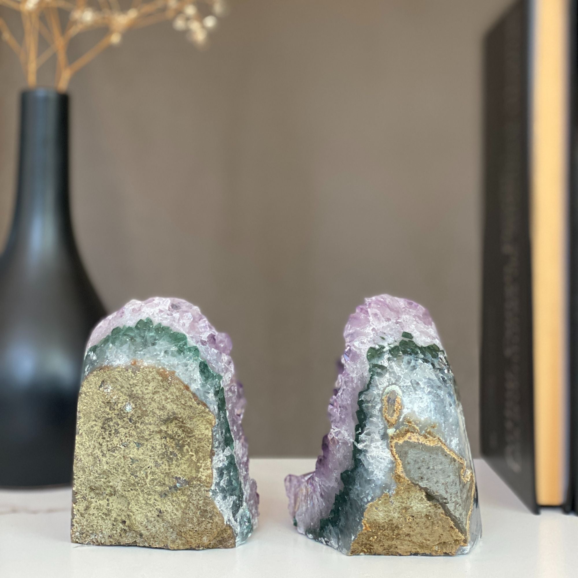 Pair of natural amethyst geode bookends with sparkling purple crystals and green-gray agate bands.